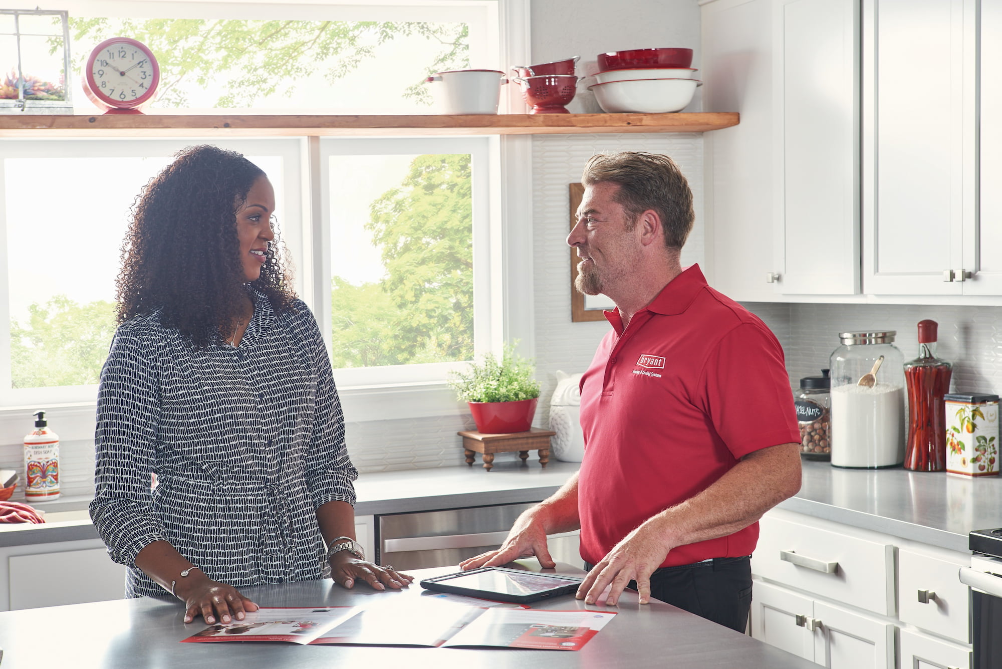 Bryant salesperson meeting with homeowners at kitchen table